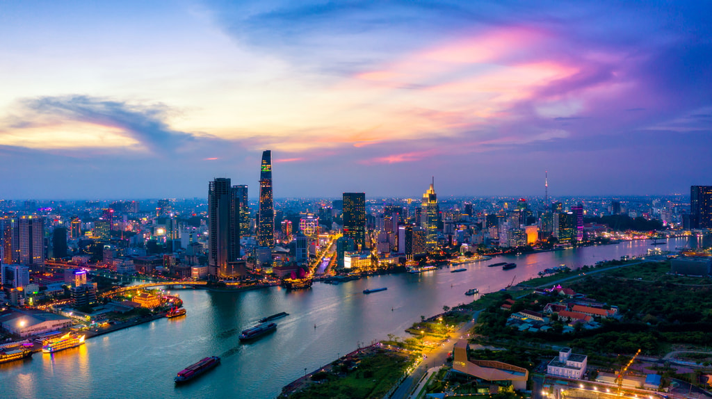 Aerial view of Ho Chi Minh City skyline and skyscrapers in center of heart business at Ho Chi Minh City downtown. Panorama of cityscape on Saigon river in Ho Chi Minh City at Vietnam at sunset scene