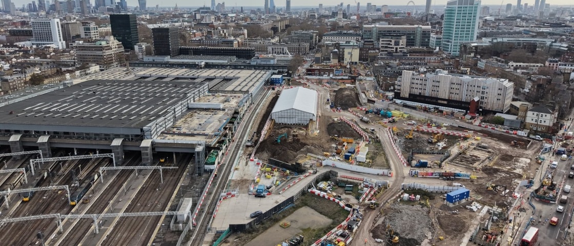 Aerial view of the HS2 Euston construction site showing rail infrastructure, active work zones, temporary roads, and surrounding urban development.