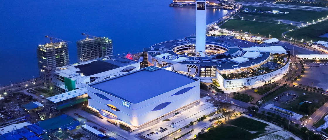 Aerial view of the SM Seaside Cebu complex at dusk, highlighting the arena, shopping centre and surrounding waterfront development.