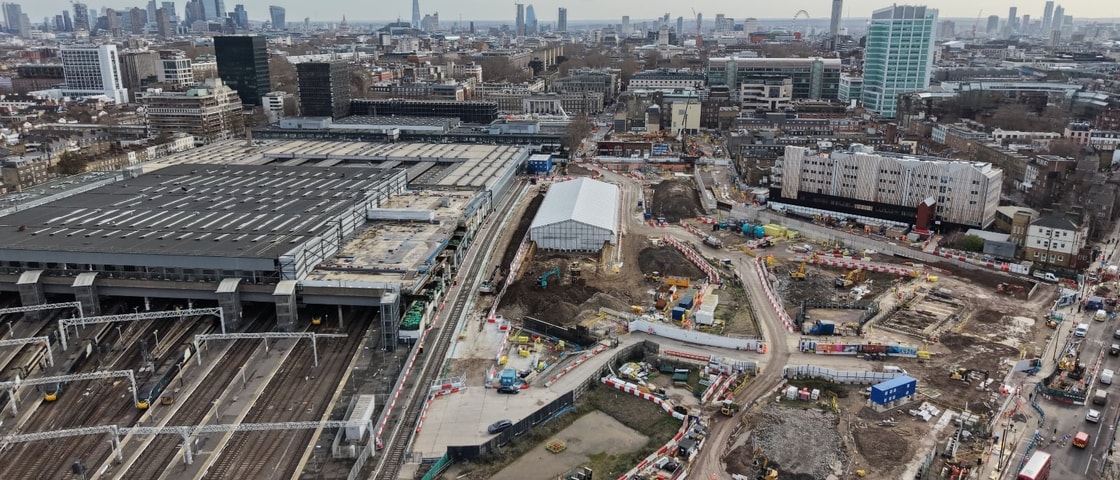 Drone view of the Mace Construct HS2 Euston project showing active rail infrastructure, construction works, temporary site buildings, and surrounding urban London landscape.