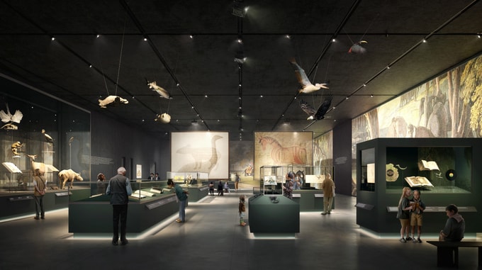 Visitors explore a museum gallery featuring natural history exhibits, suspended wildlife models, manuscripts and interactive displays.