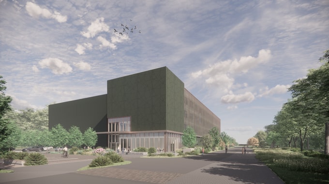 Exterior view of the Natural History Museum project showing a large modern green building with glass entrance, surrounded by landscaped greenery and a paved walkway.