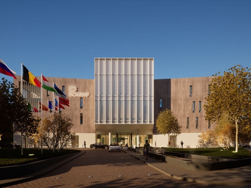 Front view of the European Centre for Medium-Range Weather Forecasts (ECMWF) Headquarters, showing a modern facade with tall glass panels and a row of international flags at the entrance.