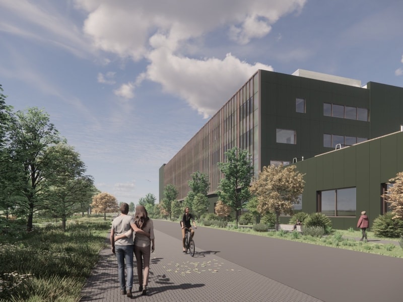 Exterior view of the Natural History Museum project showing a modern green building surrounded by trees, with people walking and cycling along a landscaped pathway.