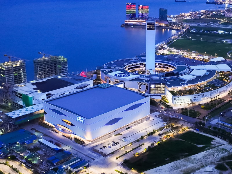 Aerial view of the SM Seaside Cebu complex at dusk, highlighting the arena, shopping centre and surrounding waterfront development.