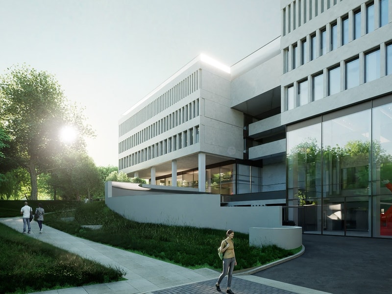 Modern building with large glass windows, surrounded by greenery, as people walk along a pathway in the serene morning light.