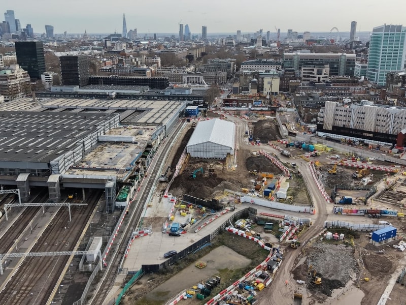 Drone view of the Mace Construct HS2 Euston project showing active rail infrastructure, construction works, temporary site buildings, and surrounding urban London landscape.